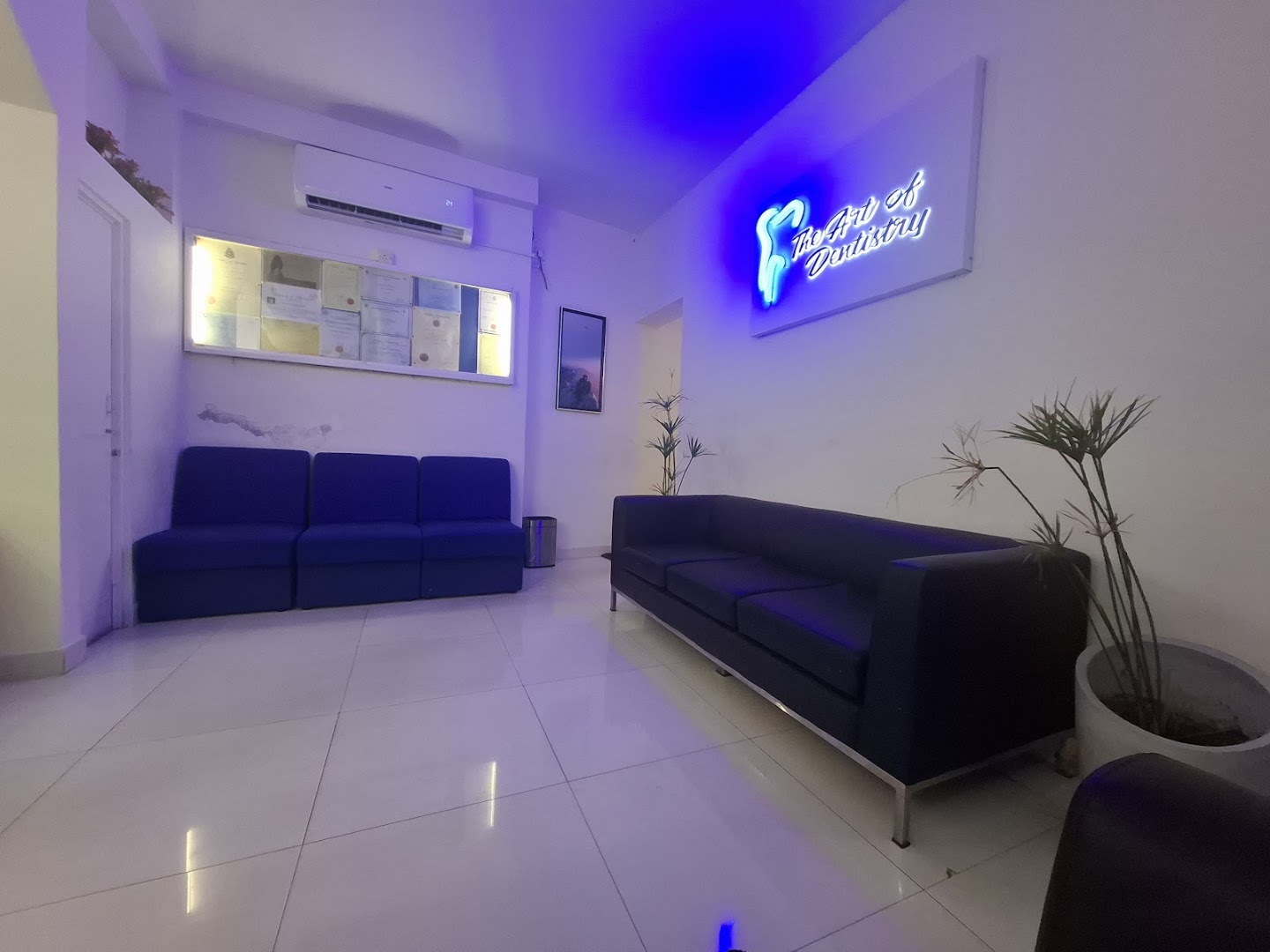 Waiting room with navy seating and blue illuminated signage